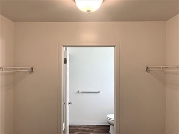 A small bathroom with a toilet and a white door